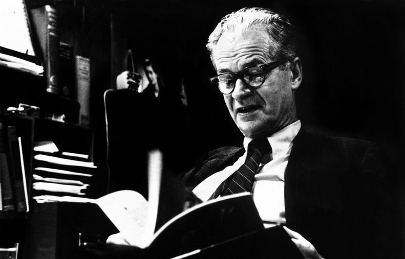 Image of B. F. Skinner, an American psychologist reading a book.