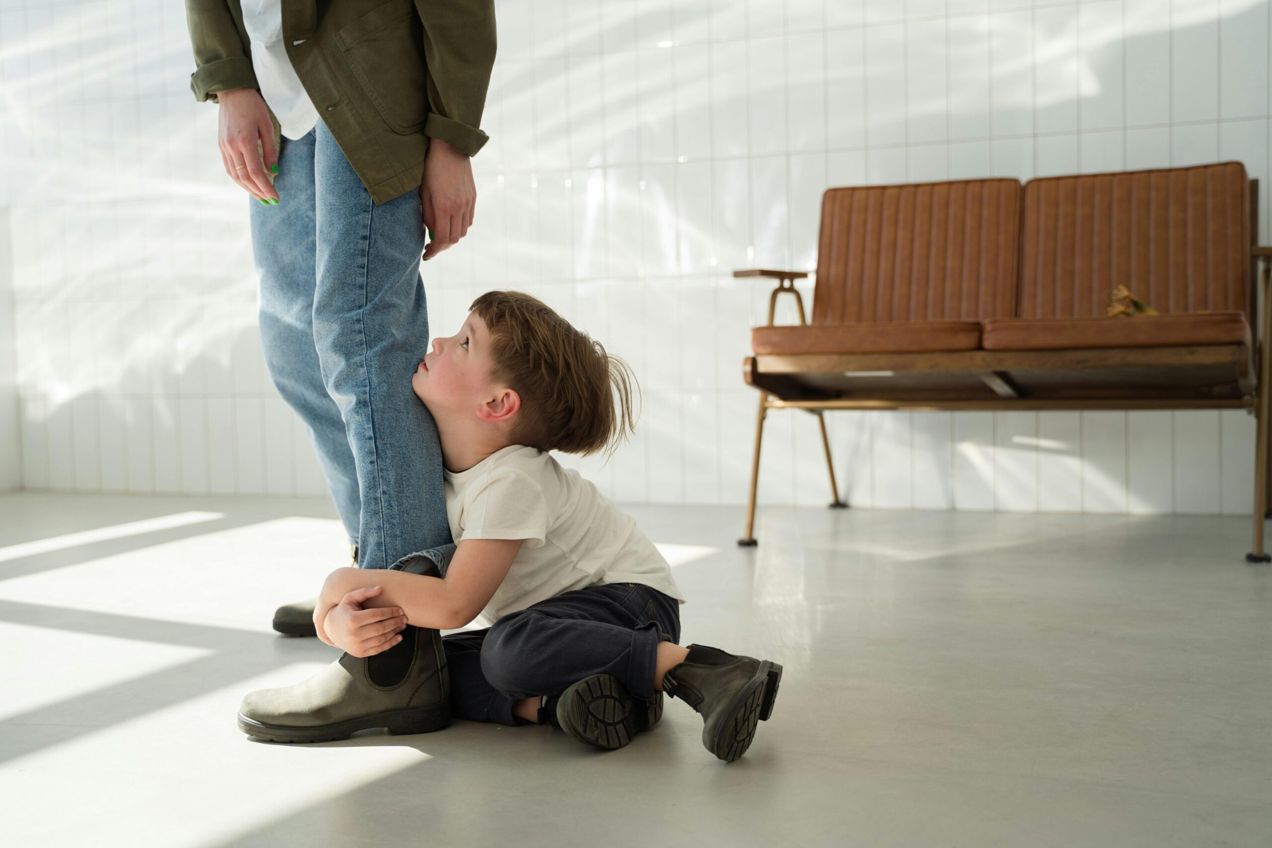 Parent and child sitting calmly together on the floor after conflict, practising co-regulation.
